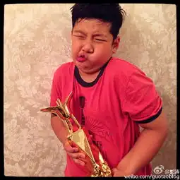 郭涛儿子抱上影节奖杯摆搞怪动作图
